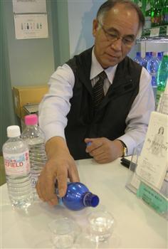 試飲をすすめるミネラルウオーター専門店「バーミーズ」の羽生則昭さん=東京都北区王子